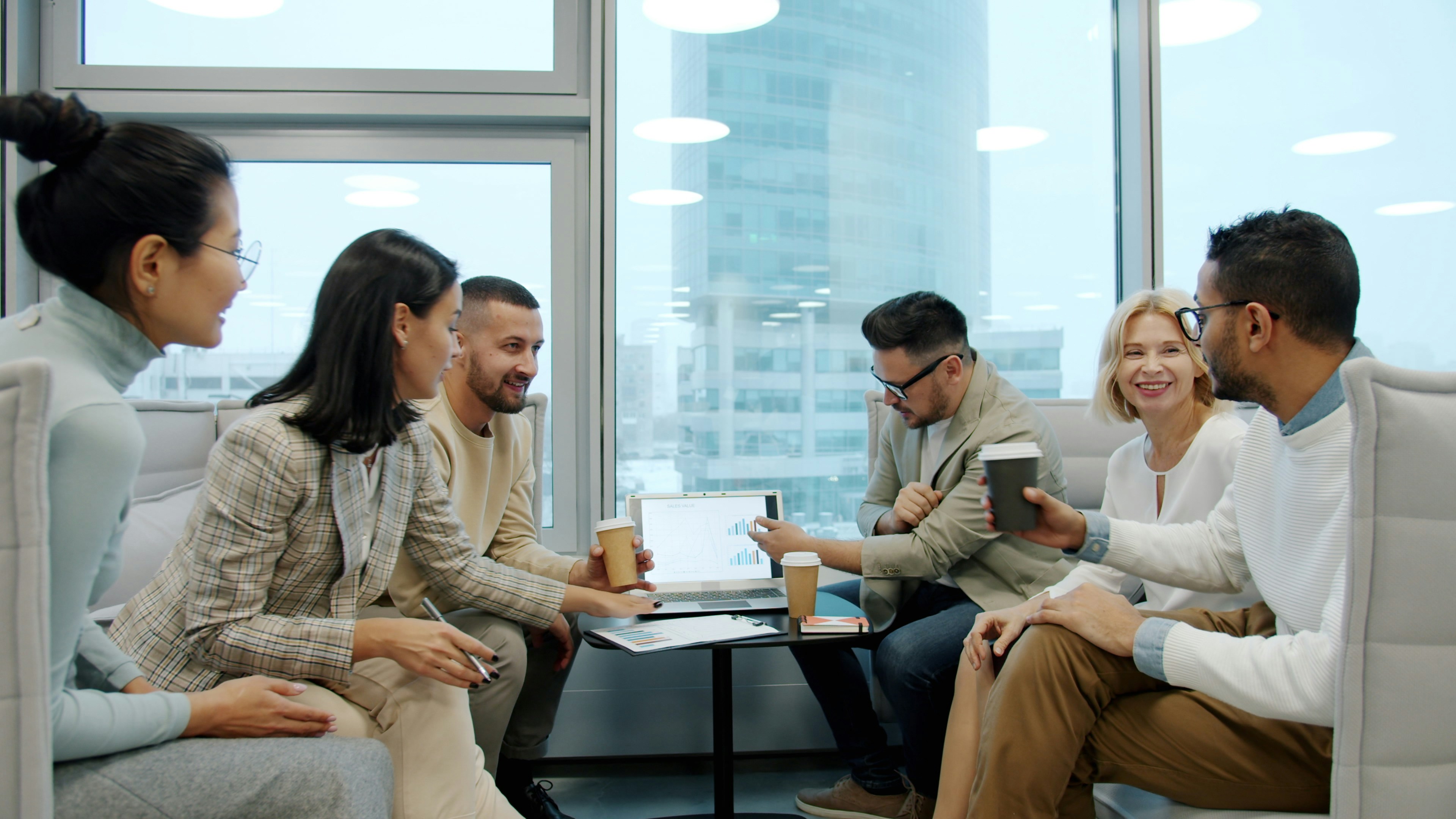 Diverse team in a market research meeting with charts and data